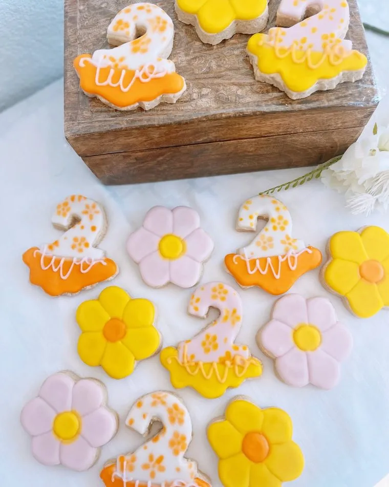 Iced sugar cookies shaped as daisies and the number two